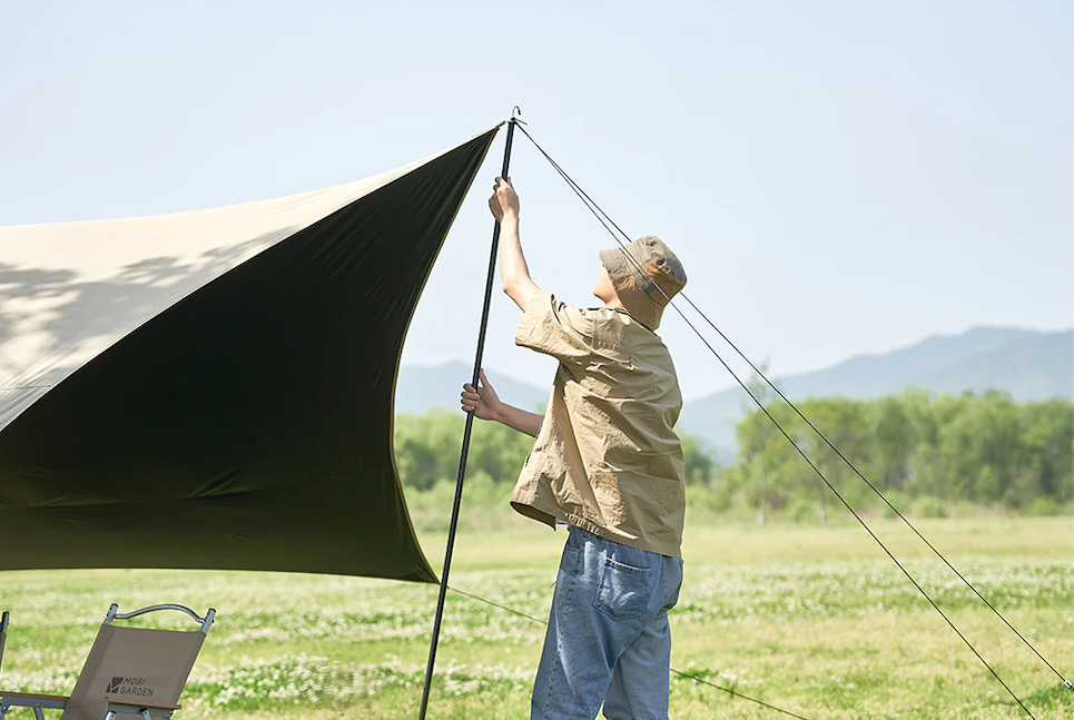 man putting up a tent