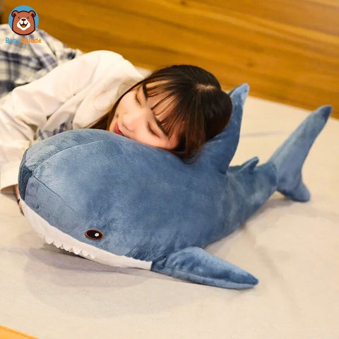 Peluche Requin - Une fille qui utilise la peluche comme oreiller