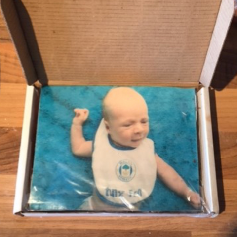 Picture of a baby printed on a cake. The very first PostCake