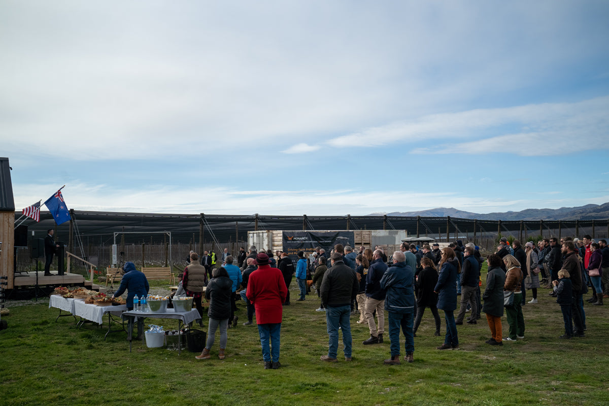 Large group of people gathering to see Monarch Tractor Demo