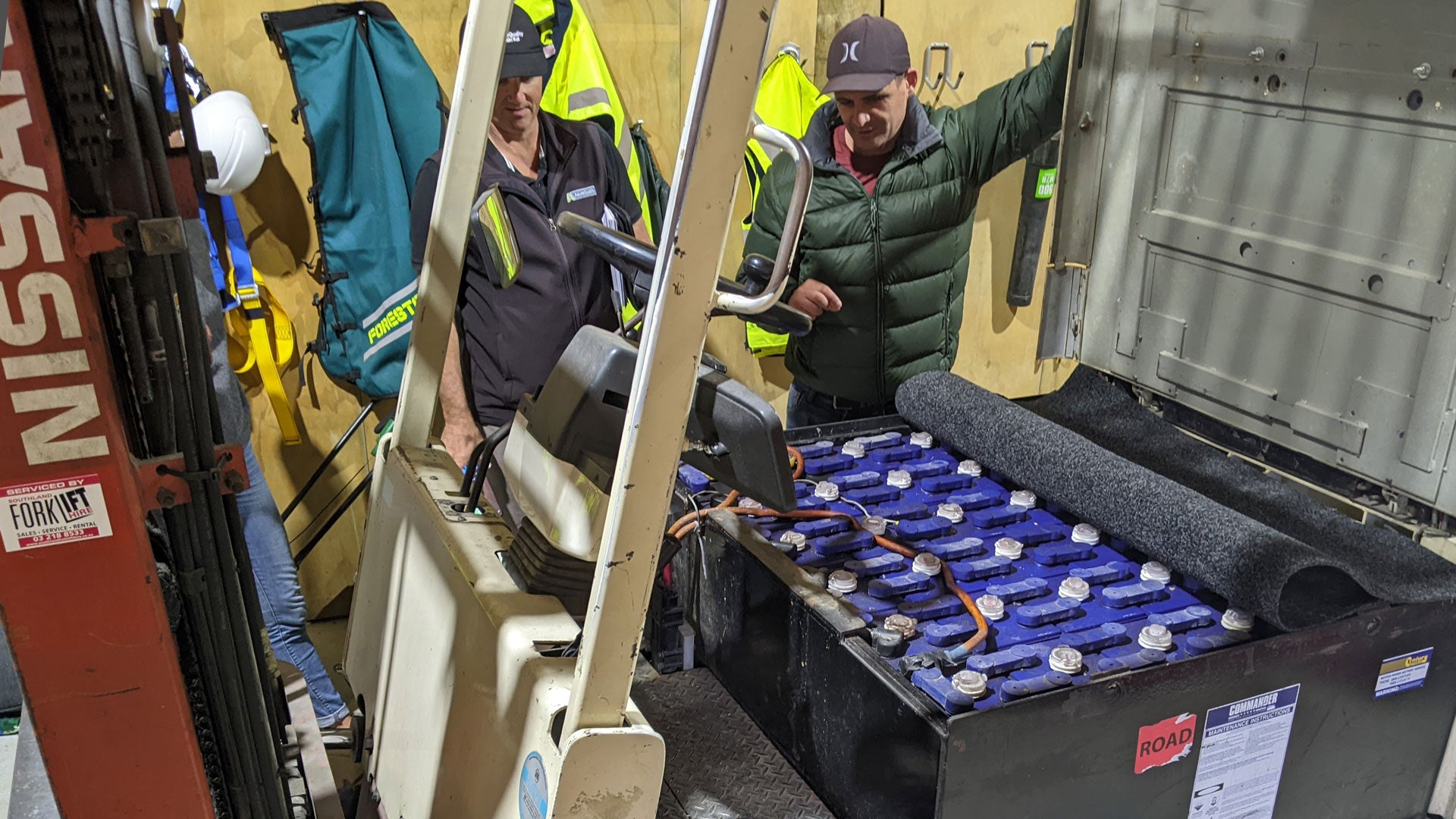 AsureQuality team inspecting the forklift and battery setup.