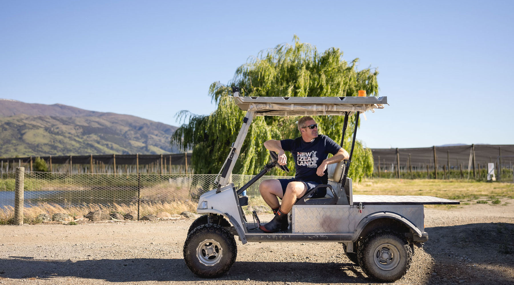 Orchard manager Euan White sitting in one of the Orchards electric golf carts.