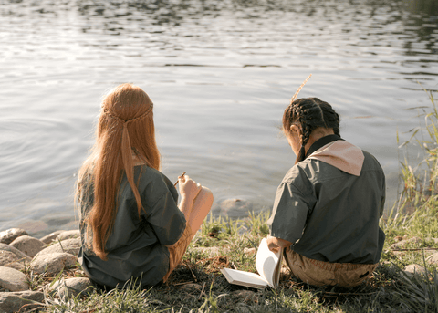 Kids sitting by water