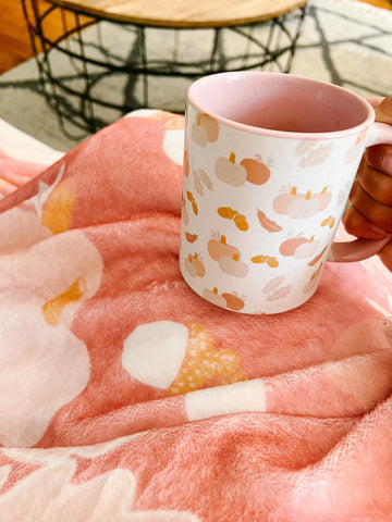 cozy mug and blanket together on couch