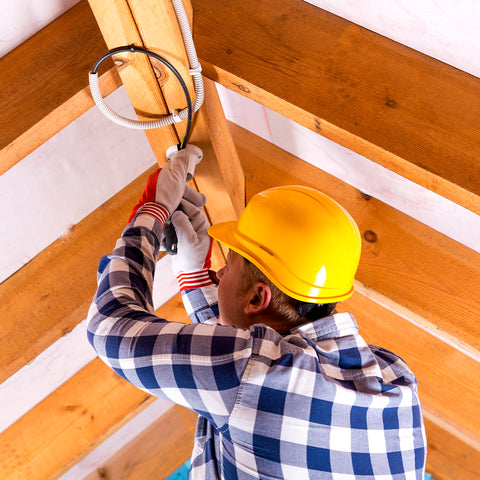 man wiring in ceiling