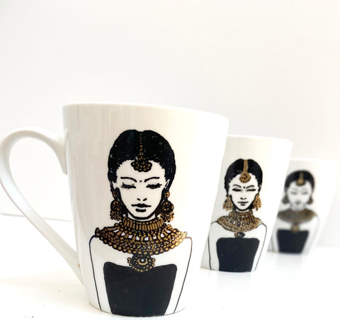 hand painted mug with black and gold illustration of woman 