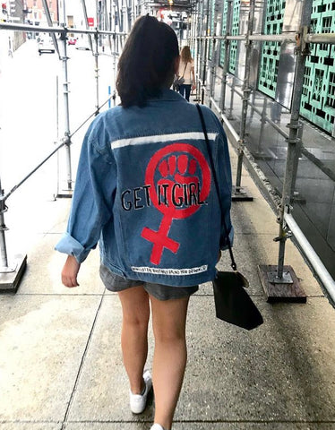 Feminist Hand Painted Upcycled Denim Jacket with the symbol for women in read. The text reads "get it girl."