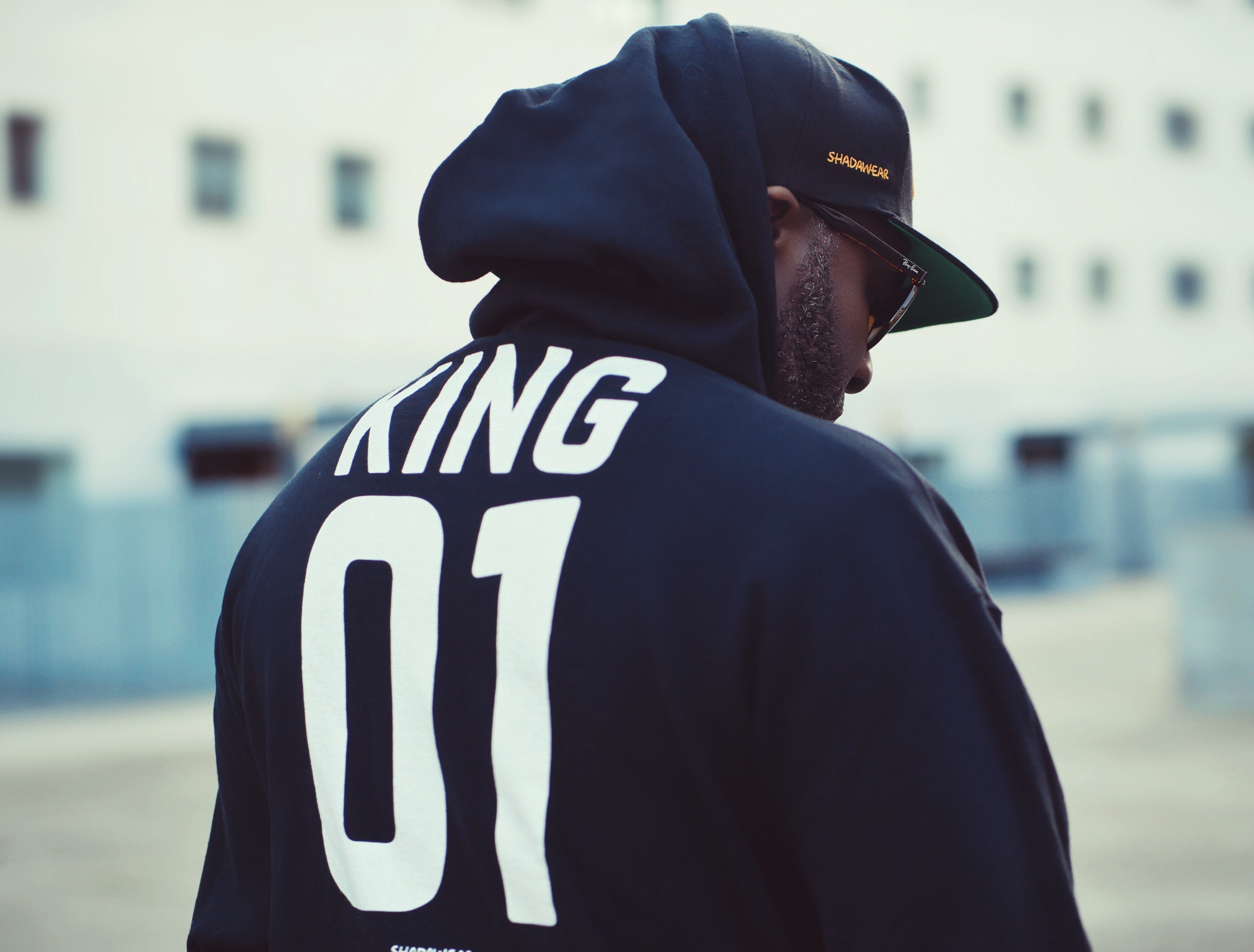 Black Man Wearing a Black Graphic Hoodie