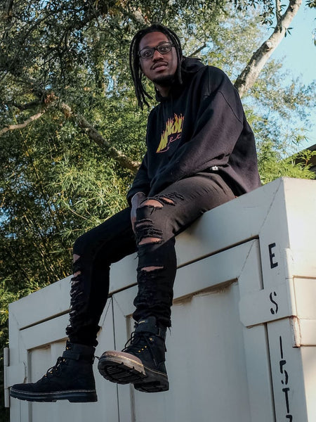 Trasher hoodie with black pants and boots