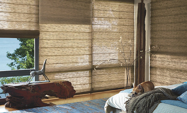 Vintage bedroom floor-to-ceiling windows covered by motorized woven wood shades