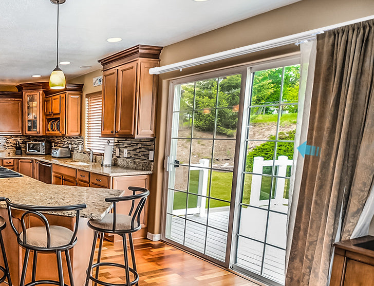 The elegant design of the kitchen complements the calm fabric of the Drapery on the sliding doors