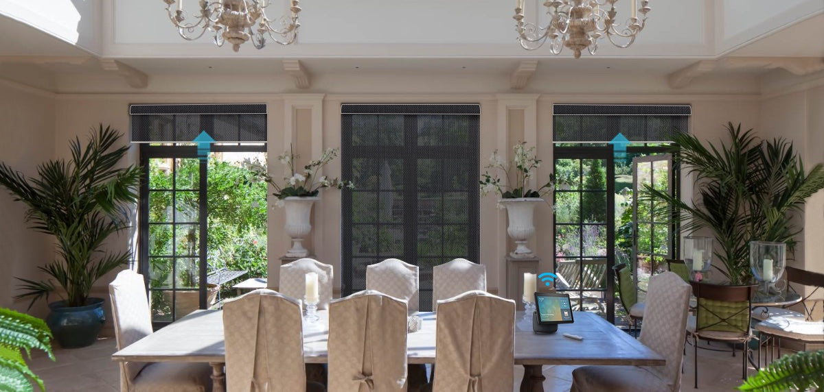 The greenery and sunlight from the courtyard pour into the living room through the Solar Shades