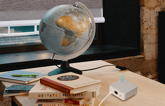 Globe, books and smart-link pro hub are on the table.