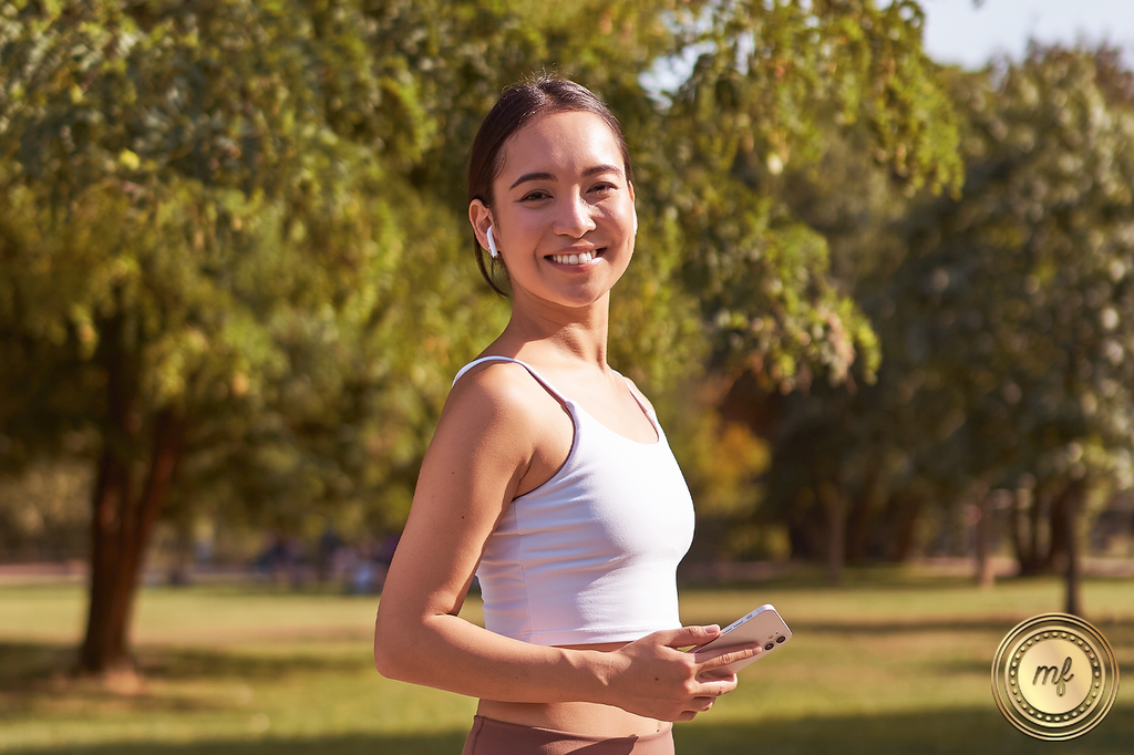 A lady exercises in a green field, feeling the freshness