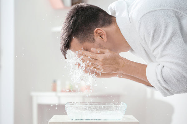 men washing face