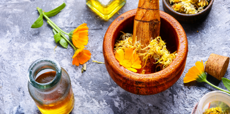 calendula in wooden mortar and pestle
