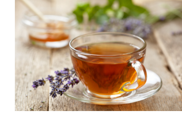 cup of herbal tea next to lavender