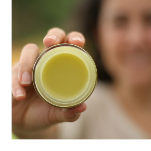 Herbal salve texture person holding jar