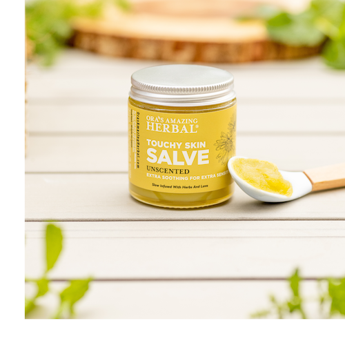 Ora's Amazing Herbal Touchy Skin Salve outdoor on wood