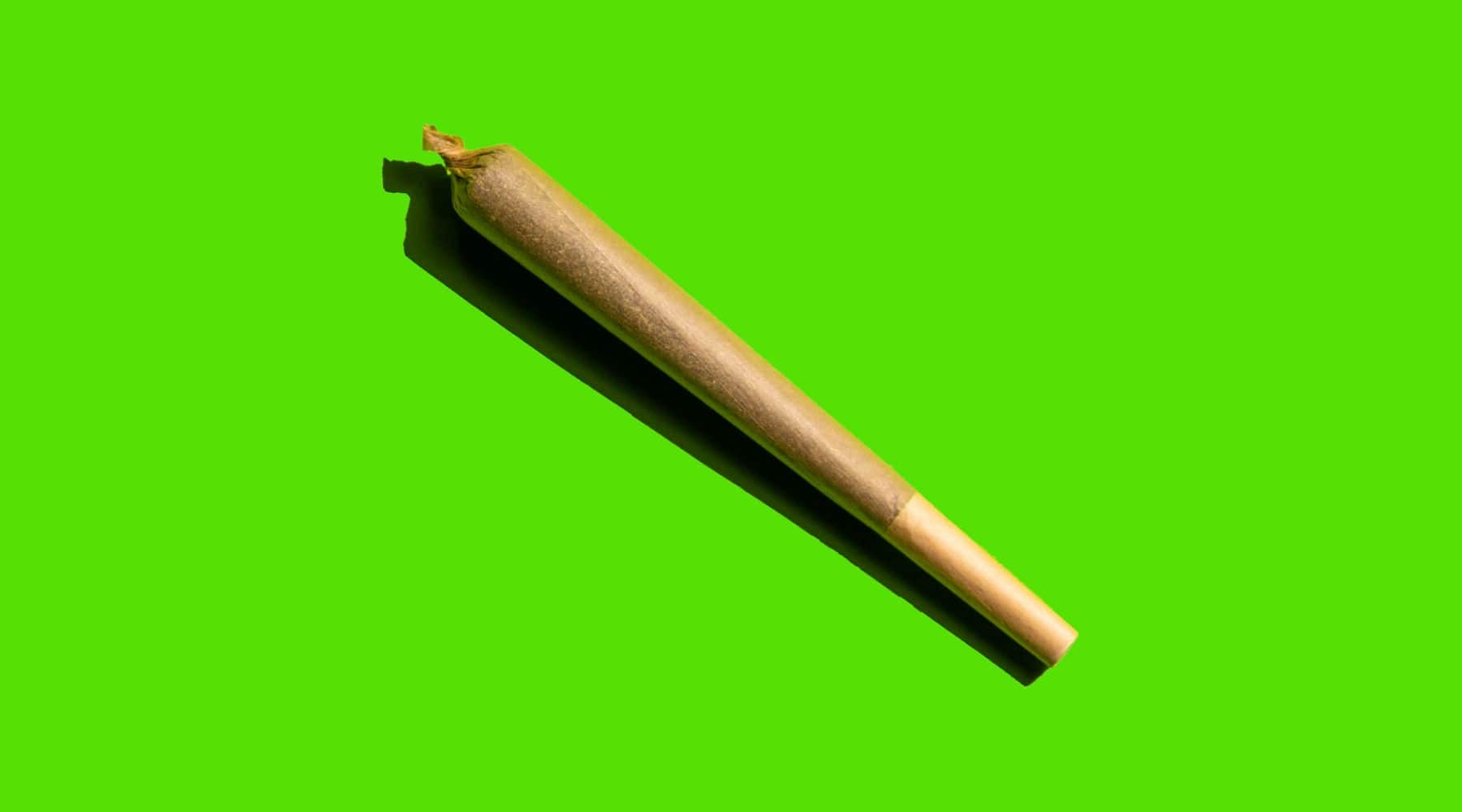 a THC joint on a green background