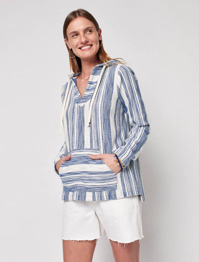 front view of model wearing islet knit poncho with white shorts