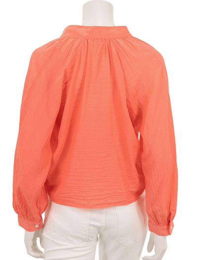 back view of the sunburst top in hot coral
