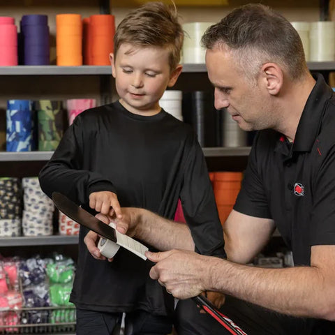 Child choosing an appropriate hockey stick