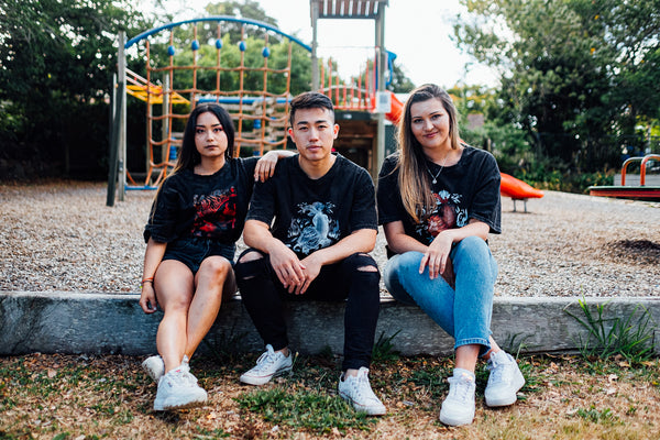 three people wearing tsrang label tshirts