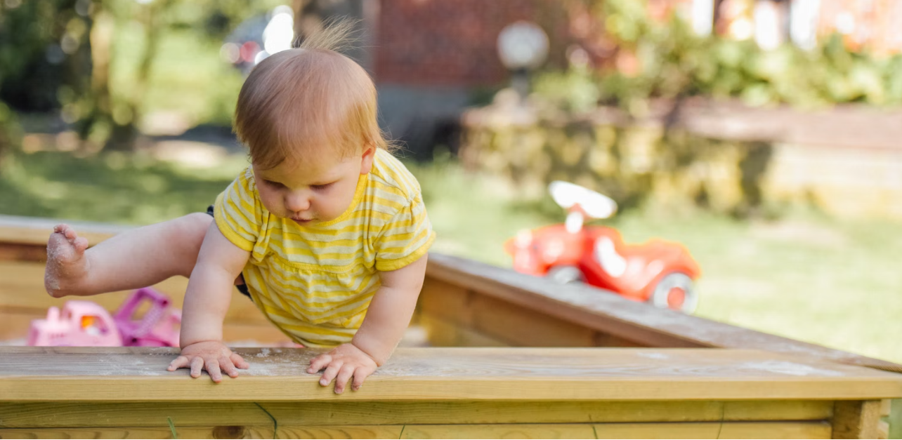 toddler playing on a playground