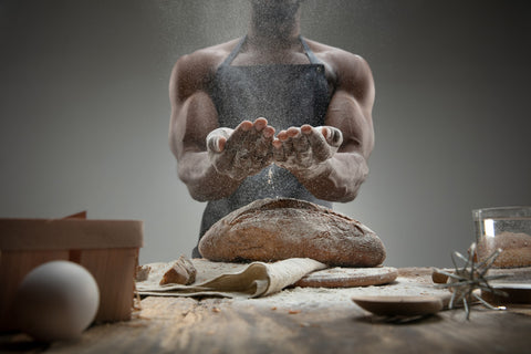 Man baking ancient roman bread