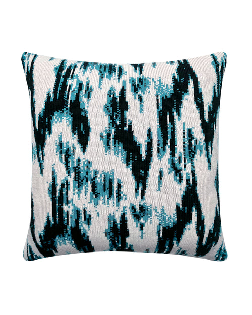 a knitted cushion in ikat print