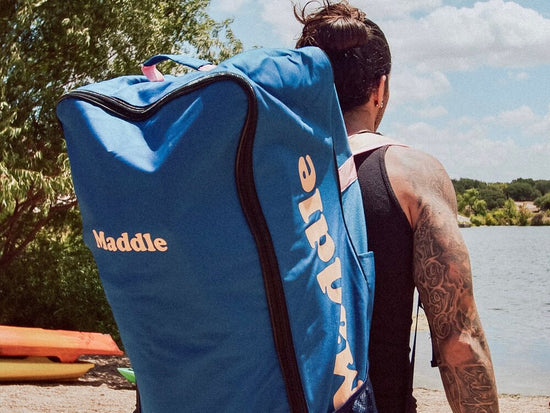 man carrying paddle board backpack