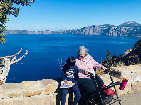 Grandma and Grandson sit in front of Crater Lake