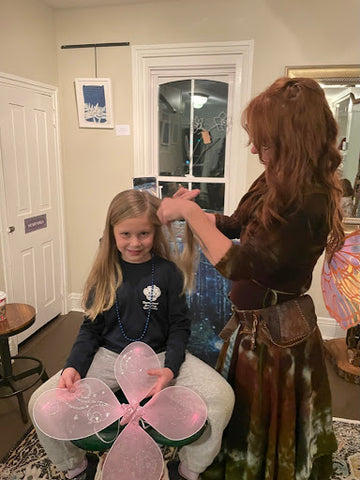 child receiving fairy hair from kelly