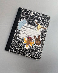 stickers on a competition notebook: a manatee, pixel longhorn skull, lightening bug, and llama face