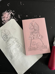 pink eraser block with the gnome drawing beginning to be carved