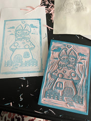 gnome block print inked with a light blue color next to the resulting print