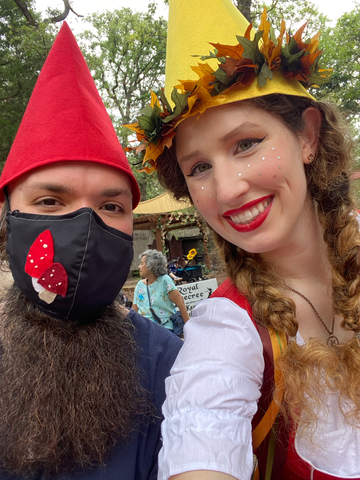 two people dressed up with gnomes, boyfriend is wearing a black mask with felt mushrooms