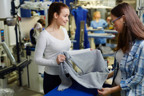 Lady checking if fabric is produced in an environmentally friendly manner
