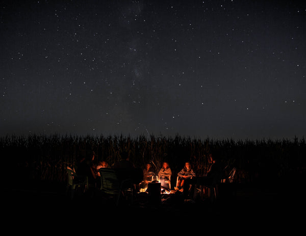 Group gathered around a campfire at night
