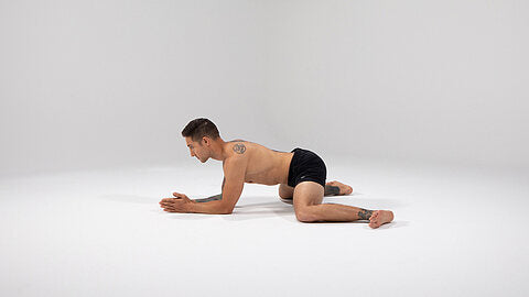 A man performing a frog stretch