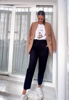 Brown blazer with a bottom of a woman's t-shirt with a print of the essence of sub-Saharan Africa