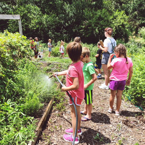 children helping in community garden