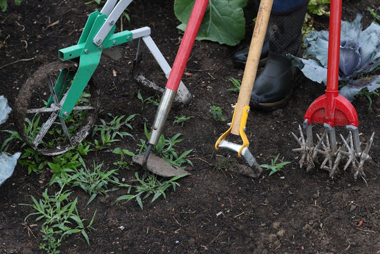 4 weeding tools in garden