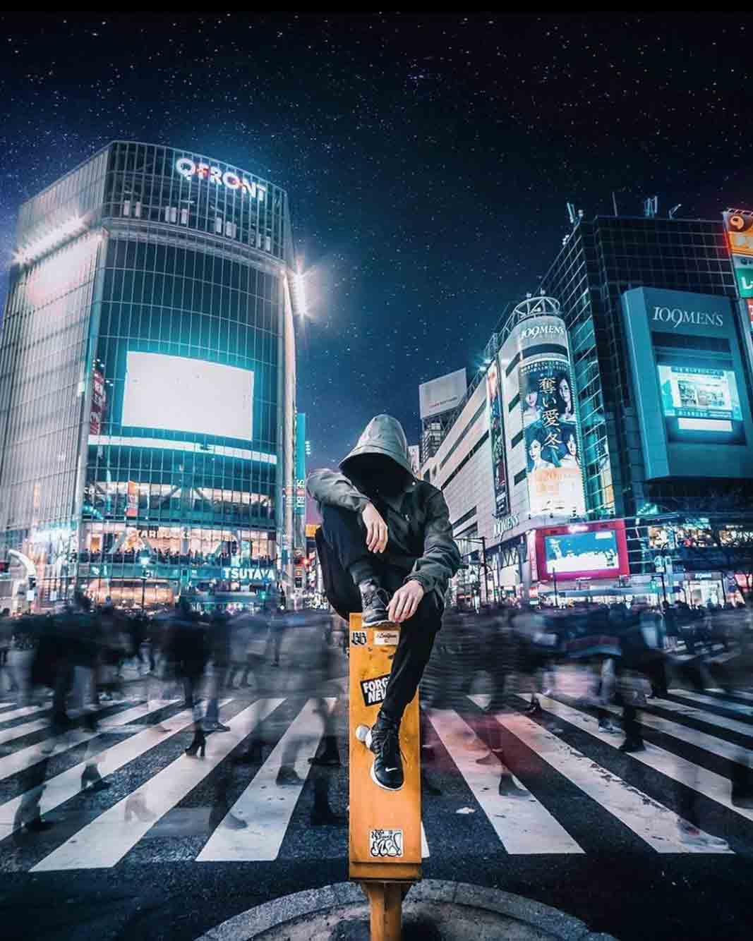 A man with techwear Japan outfit in the middle of Shibuya street