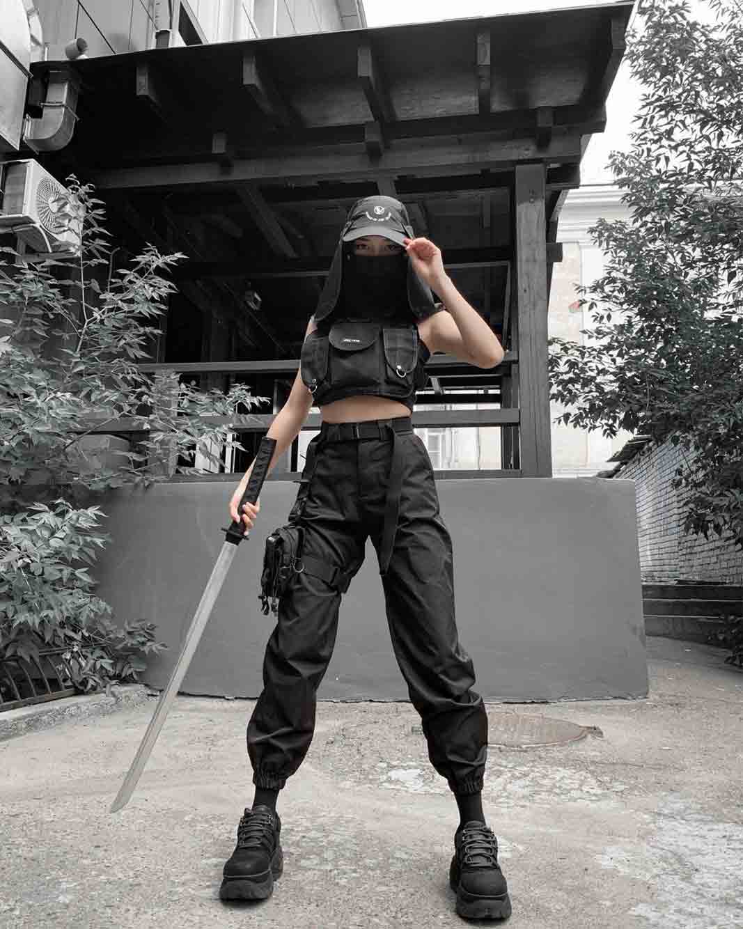 techwear ninja woman with a katana, a black cargo pant and a hat