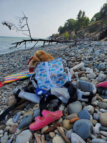 tote on a rocky beach with other items
