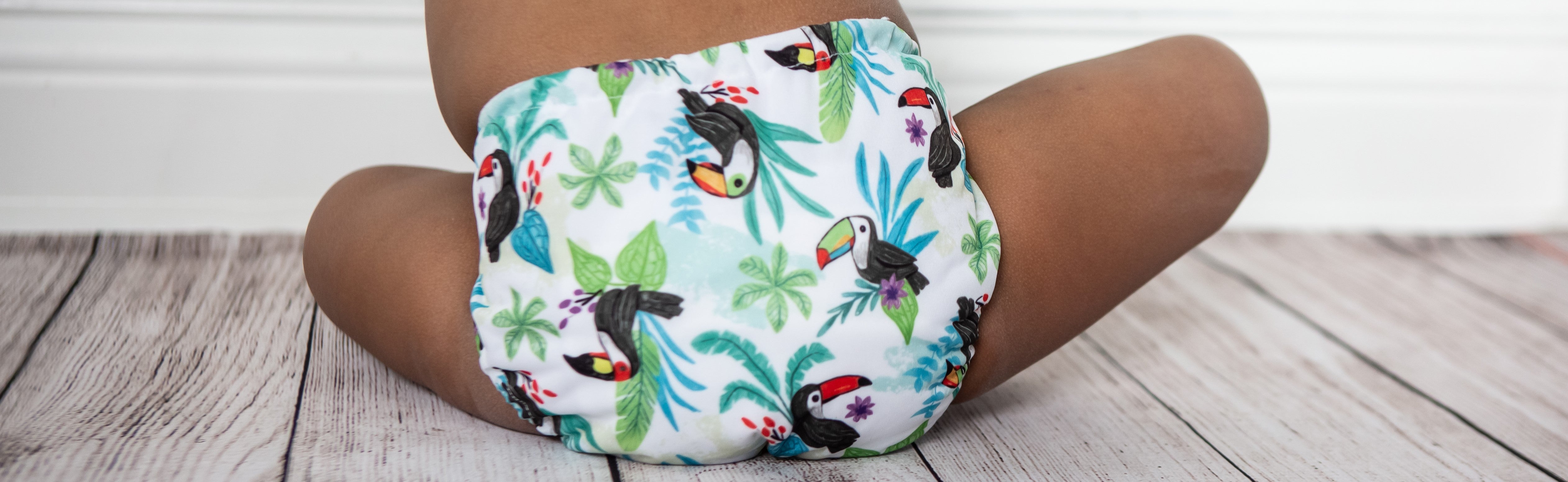 Image of baby wearing Thirsties One Size All in One in Toucan