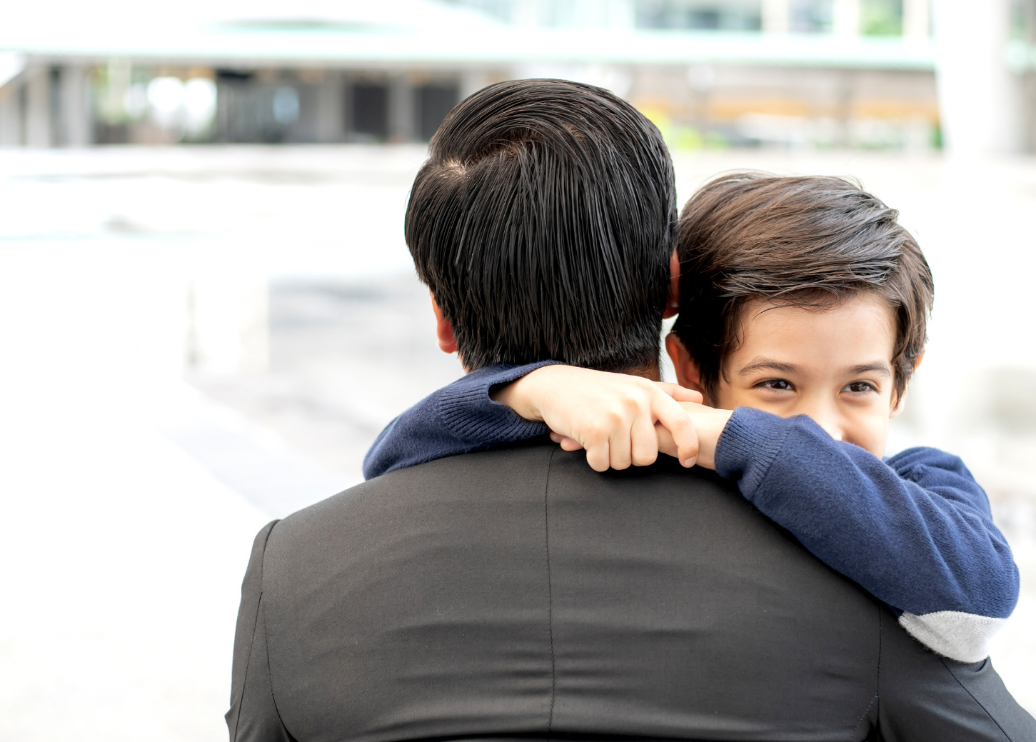 image of boy hugging adult