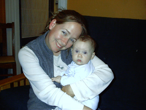 Erin Kimmett, Thirsties founder, holding her infant daughter and smiling.